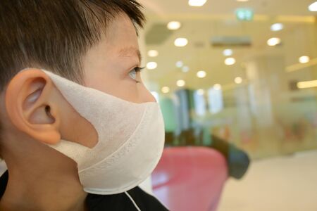 cute kid wear hygienic face mask protection care your self from disease spread infection and air pollutionの写真素材