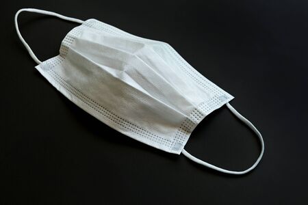medical hygiene face mask isolated on black backgroundの写真素材