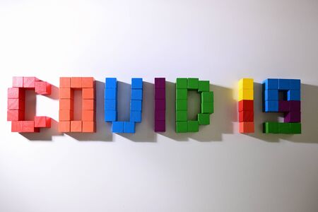 topic COVID-19 text message from wooden block toy of kid on white background