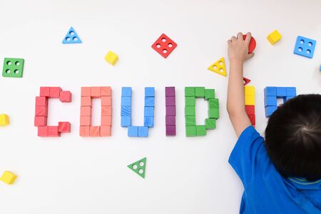 kid learning study topic COVID-19 coronavirus from wooden block toy