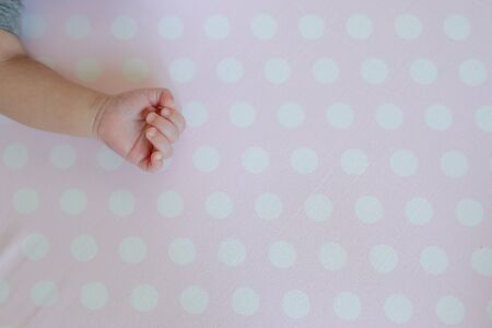little hand of baby newborn on pink backgroundの写真素材