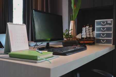 table work with desktop pc computer on desk inside room of business home officeの写真素材