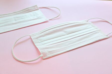 medical hygiene face mask on pink background