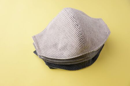 heap of fashion mask handmade from fabric cloth on yellow background for sale
