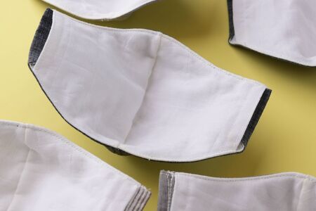 cloth mask material with white salu muslin fabric soft textile, group of objects put on yellow backgroundの写真素材