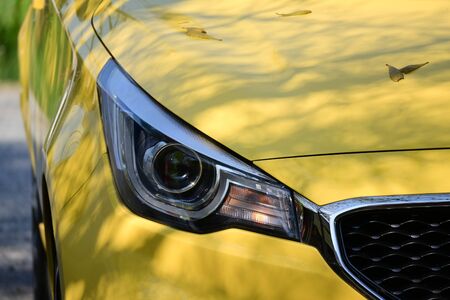 headlight of yellow modern car, image concept of summer road trip travel の写真素材