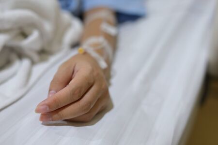 iv infusion intravenous injection of patient illness lying on bedの写真素材