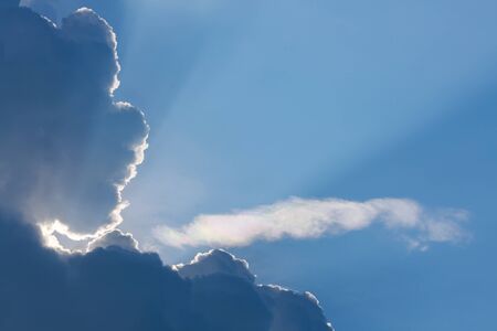 sun light shine through cloud on clear blue sky background