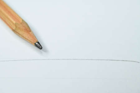 wooden pencil on white paperの写真素材
