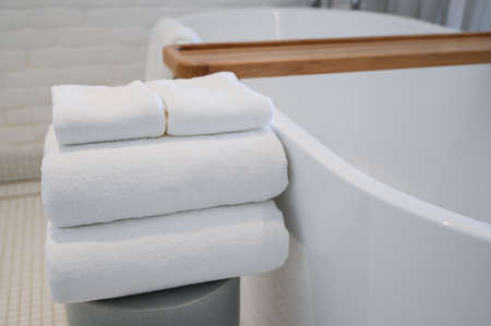 white towels put on bathtub in the bathroom