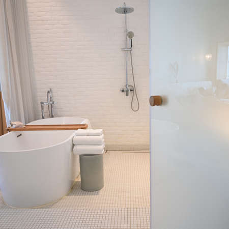 white bathroom with towels and bathtub