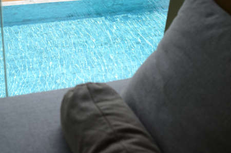 gray pillow put on bed, pool view