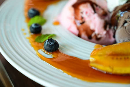 ice cream and fruit on plateの写真素材