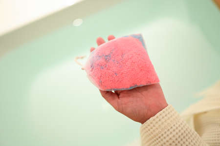 pink bath bomb on woman hand, relaxation timeの写真素材