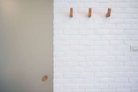 wooden hanger hook on white brick wallの写真素材