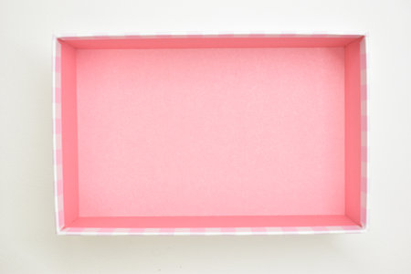 open beautiful pink box on white background, package for designの写真素材