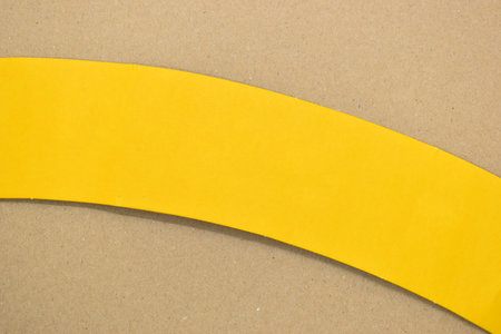 yellow curve paper put on brown background, paper industry