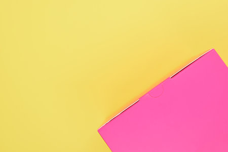 pink paper box on yellow background, package for design