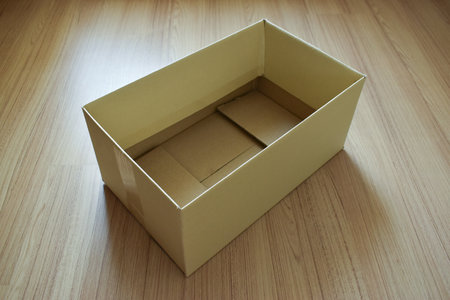 brown post box packaging put on wood floor for shipping, paper textured