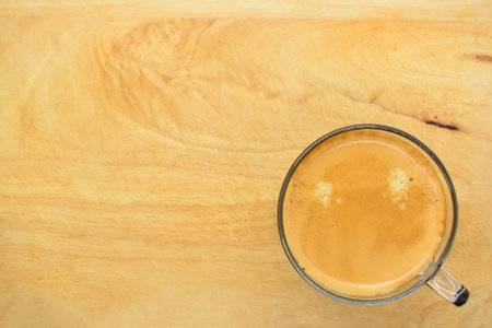 glass of hot black coffee put on wood backgroundの写真素材