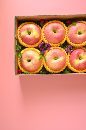 beautiful apple in the box on pink backgrond, healthy fruit