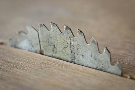 sharp metal saw on wood plank texture background, construction machineの写真素材