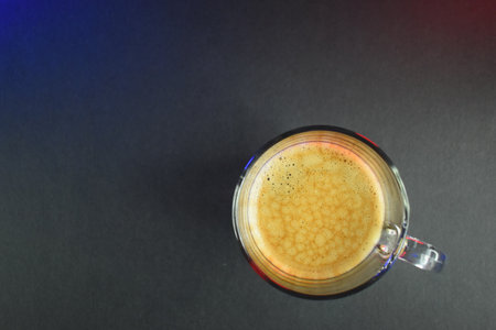hot black coffee on black table with neon lightsの写真素材