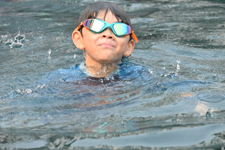 happiness little boy swimming in the pool on summertimeの写真素材