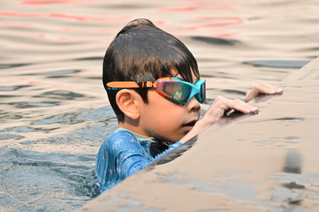 happiness little boy swimming in the pool on summertimeの写真素材