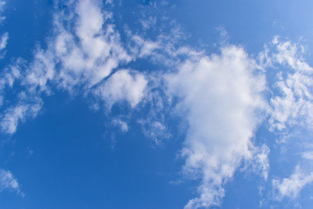 beautiful blue sky and white fluffy group of clouds with sunrise in the morning, natural backgroundの写真素材