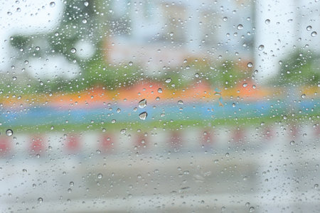 blur street background on rainy day, water drop on blurred road viewの写真素材