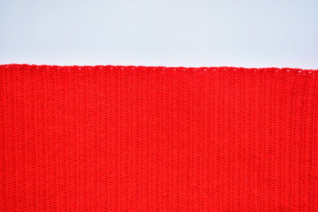 red wool knitted yarn texture, woolen fabric on white background