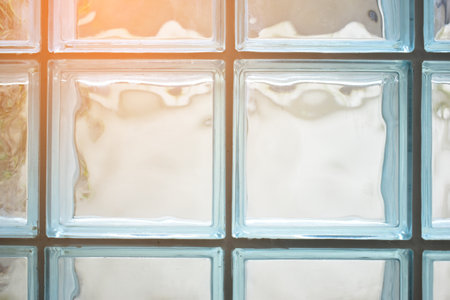 close up glass block wall with golden natural light background, interior designの写真素材