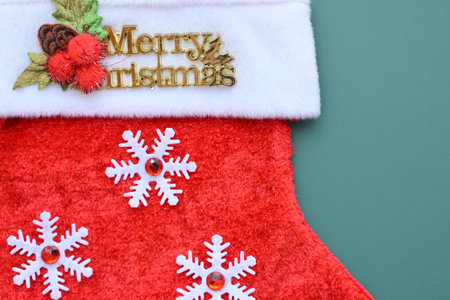 red wool winter sock on green background, christmas decorationの写真素材