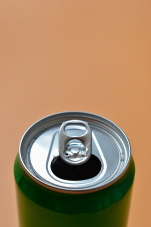 aluminum green drink cans on orange background, open cold fresh beverageの写真素材