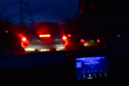 light of car on road with accident in the night, blurred background in rainy dayの写真素材