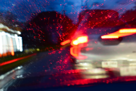 light of car on road with accident in the night, blurred background in rainy dayの写真素材