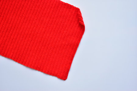 red wool knitted yarn texture, woolen fabric on white backgroundの写真素材