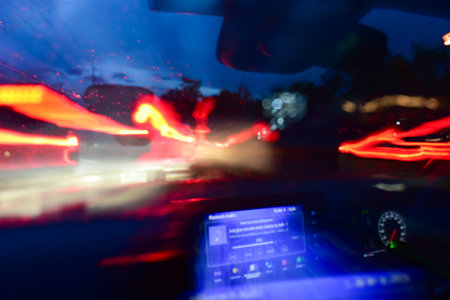 light of car on road with accident in the night, blurred background in rainy dayの写真素材