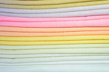 stack of colourful cotton clothes, close up pile of clothing