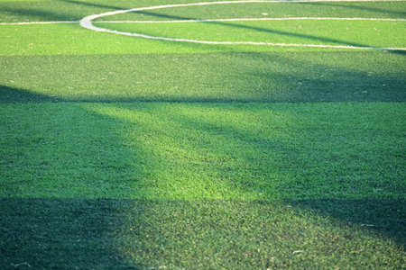 artificial green grass soccer field with sunlight, training football yardの写真素材