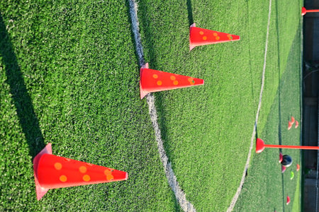 artificial green grass soccer field with orange training cones