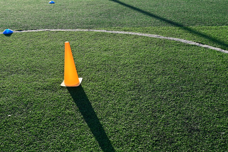 artificial green grass soccer field with orange training conesの写真素材