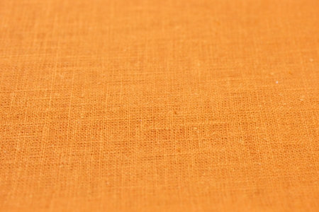 orange hemp viscose natural fabric cloth color, sackcloth rough texture of textile fashion abstract backgroundの写真素材