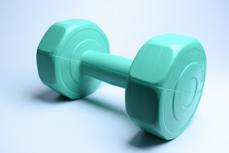 single green dumbbell on white background, object for exerciseの写真素材