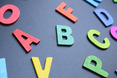 colorful letter alphabet on black background, object for educationの写真素材