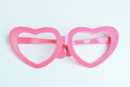 pink heart shape of glasses on white backgroundの写真素材