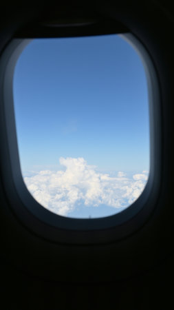 Scenery outside the window of a passenger plane, beautiful blue sky and white cloud viewの写真素材