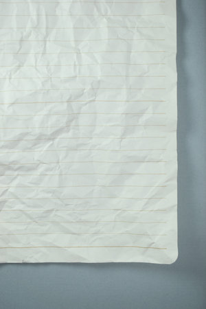 crumpled line paper texture on grey background,  blank sheet notebookの写真素材
