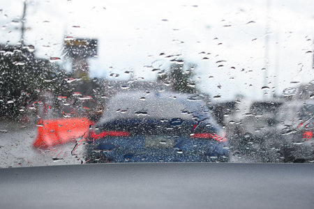 car on highway road with rainny season, blurred image
